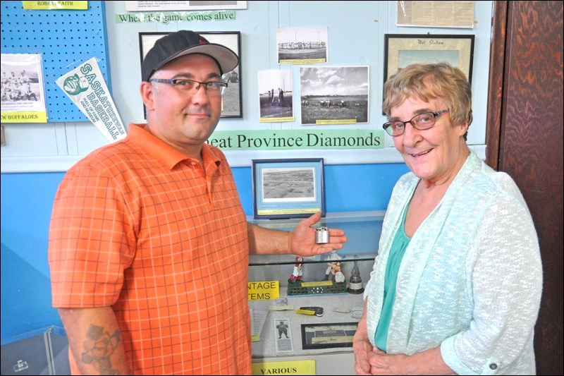 Justin Kisser, who uses a metal detector to find old coins and other historical items on grounds throughout the Battlefords, found a major item where Abbott Field used to stand: an old cigarette lighter, one that would have been presented to Jack Abbott by the North Battleford ball club in 1947. Kisser presented the item to Jane Shury of the Saskatchewan Baseball Hall of Fame and Museum, and it will now be a permanent part of the museum’s collection.