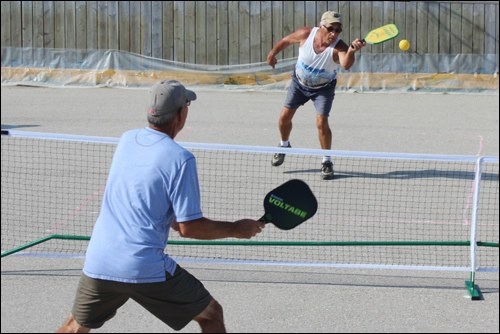 La Verne Hinzman volleys a pickleball toward Tom Goodman during a match at the Steventon Boulevard c