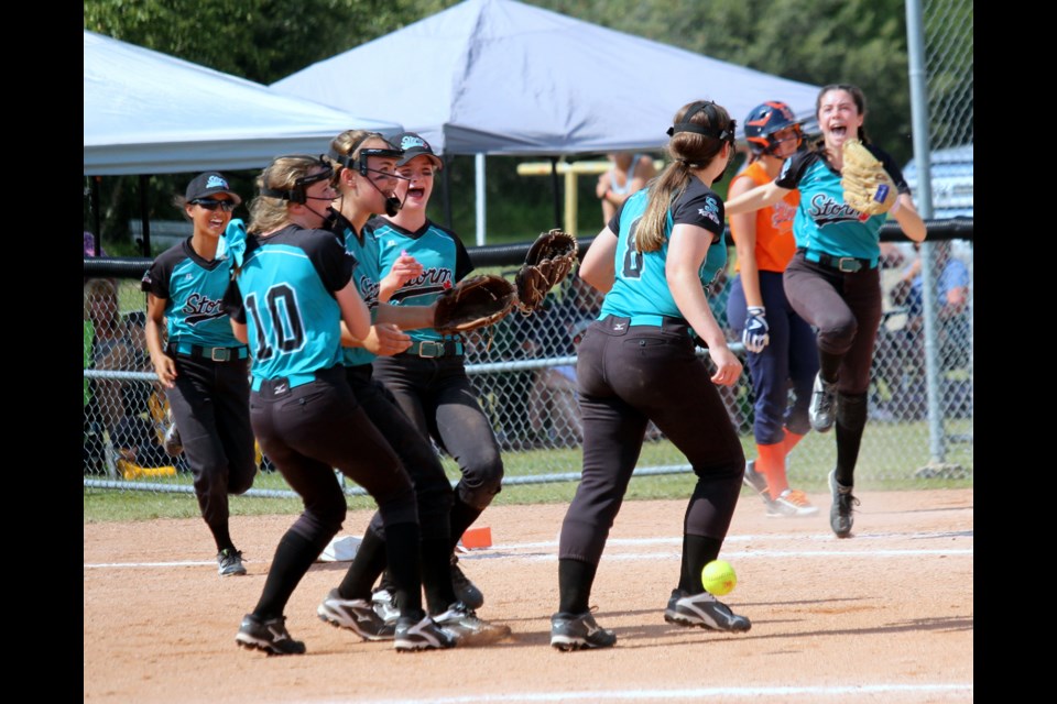 Members of the Surrey Storm raced towards pitcher Katie McMillan after their 4-3 triumph over the Lloydminster Liners in the Western Canadian U14 Softball Championship girls’ division final at Battleford Flats Park. Photo by Lucas Punkari