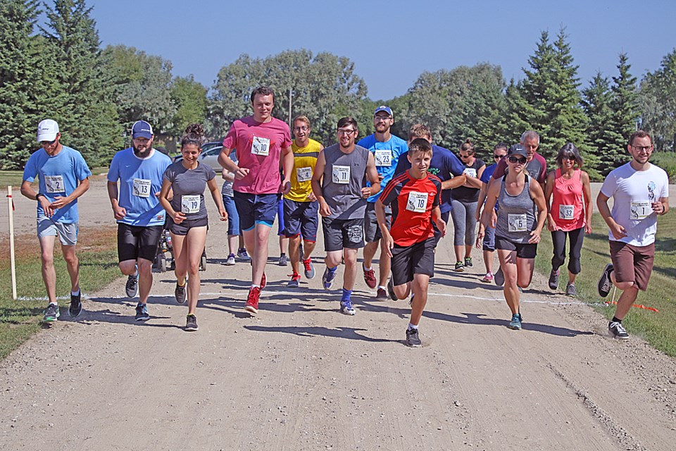 The Nipawin Bible College hosted its first Nipawin Country Mile foot race on its grounds Aug. 5. The race was a fundraiser to replace the roof on the Rempel Auditorium. Here, the The 5K and 10K racers begin. Review Photo/Devan C. Tasa