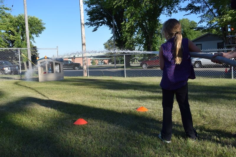 Calleigh Van Brugge quickly learned how to use a fire hose to spray a building at the end of the junior firefighter challenge course.