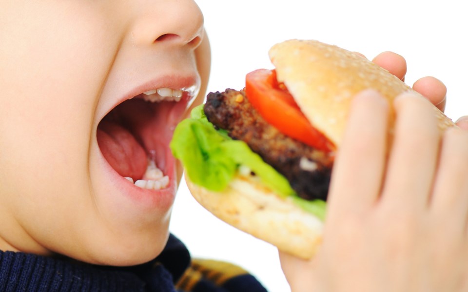 Boy eats burger