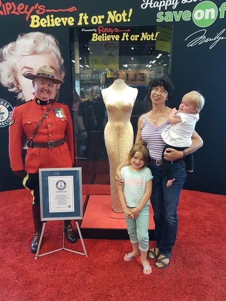 “This is a once-in-a-lifetime opportunity for me to take my granddaughters to see a dress worth $6.5 million,” said Jan Derwores of Kamsack, who had a photo taken of her with Maddison Derwores, (standing), and Lexie Derwores, when they visited the Save-On-Foods store in Yorkton. “I want to mark this event with a souvenir photo to show them when they are older. We may never have an opportunity like this again, as these events rarely happen close to home. By mid-afternoon on July 18 over 450 people had had a chance to have their photos taken with the world’s most famous dress, and the line-up was still very long.”