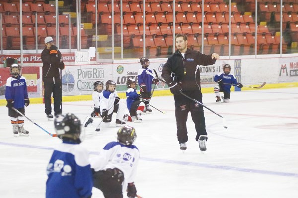 Derek Serdachny brings a group of young players through a warm up before their camp gets started.