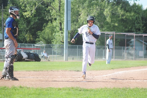 Yankees player Benny Walchuk scores a run for the Yankees early in the game on Saturday.