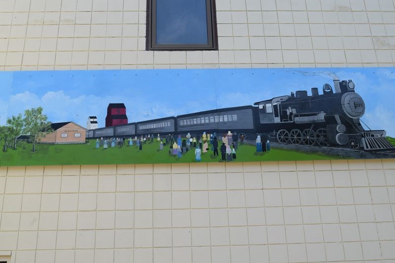 The mural on the wall of the Buchanan Community Centre depicts a scene at the local railroad station around 1910-1912.