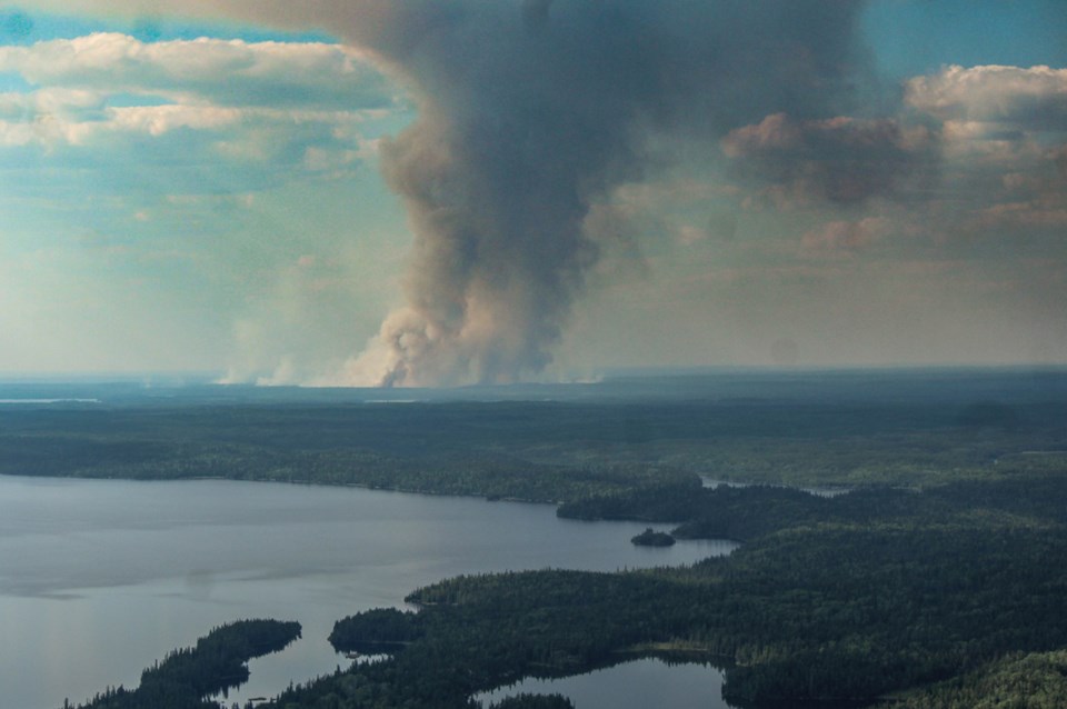 An aerial view of the Kisseynew Lake fire and plumes of smoke.