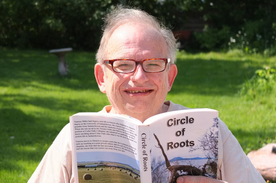 Writer Harry Hobbs with his latest self-published novel, Circle of Roots.
