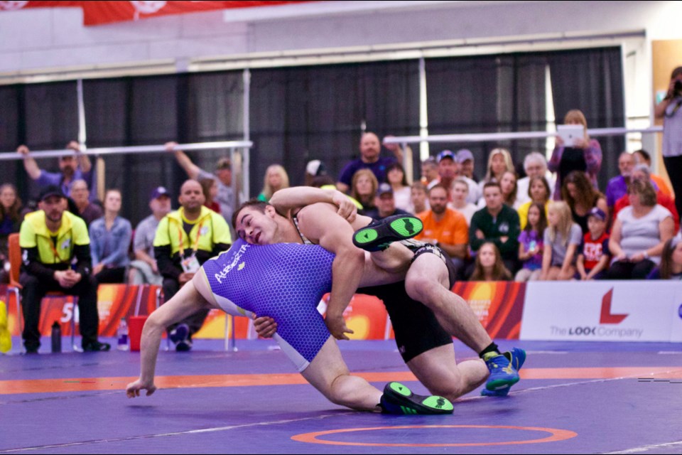 Hunter Lee gains leverage on Alberta’s Peter Waeckerlin during a preliminary round match at the Canada Games. Hunter won the gold medal in the men’s 98-kilogram class. - PHOTO BY KEN STERZUK/2017 CANADA SUMMER GAMES