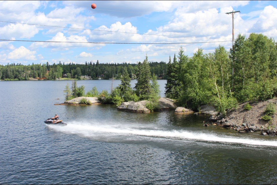 A jetskier flies underneath the Highway 10 bridge at Bakers Narrows. Many campers and cabin owners, both from far and away, have been enjoying a warm summer on Lake Athapapuskow. - PHOTO BY ERIC WESTHAVER