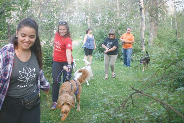 Members from Paws & Claws and Parkland Valley District give the dogs a quick walk around the park.