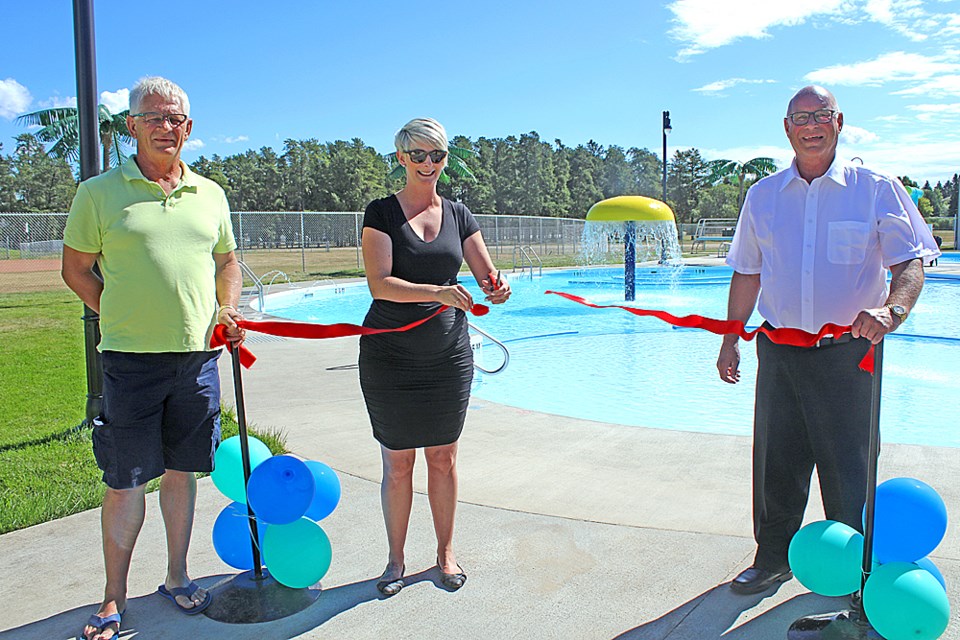 Nipawin Councillor Ray Serack, Director of Parks and Recreation Chelsea Corrigan and MLA Fred Bradshaw cut the ribbon for the town’s new pool. Review Photo/Devan C. Tasa