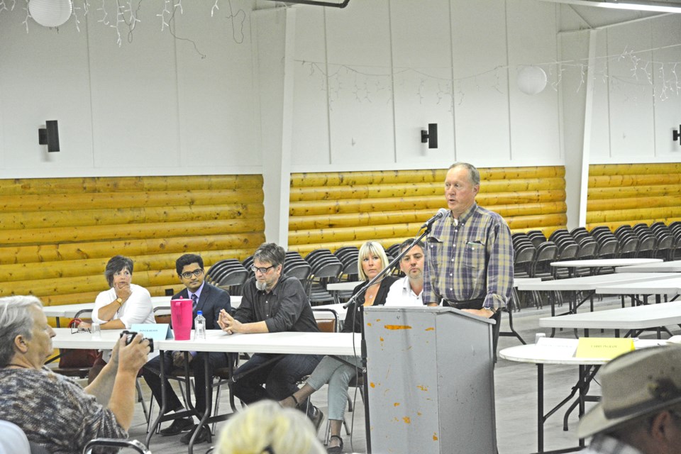 Larry Ingram chaired the meeting, with Dana Karlson, his wife Stephanie, and others looking on.