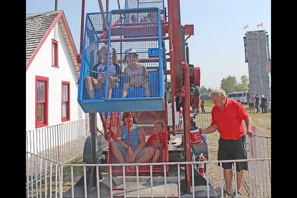 Children and parents alike enjoyed the Ferris wheel at the Hudson Bay Heritage Day Aug. 19. That was part of a homecoming weekend for the town that saw approximately 2,000 come home. Review Photo/Devan C. Tasa