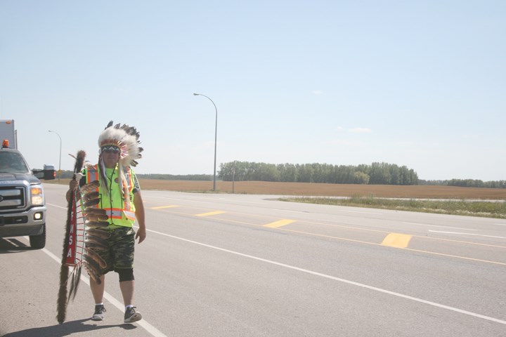 Desnomie hits the highway, left, after speaking to people, above, at his Yorkton pitstop last Wednesday.