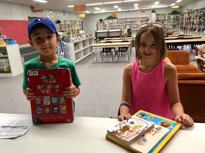 Jackson and Emerson Strykowski took advantage of the Preeceville School library being opened for short time during the summer to check out some books for reading on August 22.