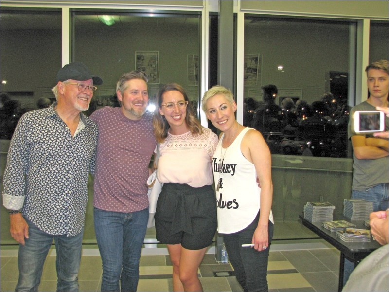 Steve (also known as Wilkie), Tyler, a fan, and Amanda Wilkinson at the Dekker Centre Wednesday last week. The audience was not large, but it was loud and appreciative of the grammy-nominated family