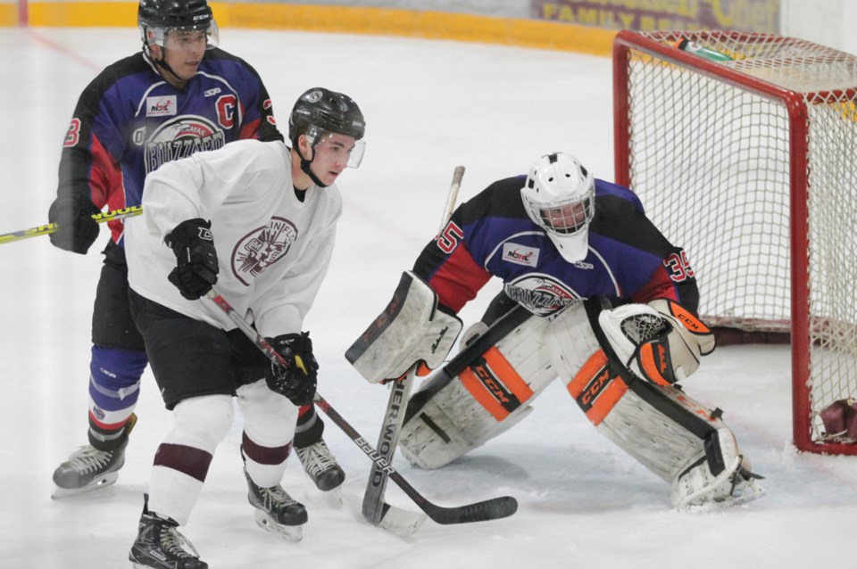 Bombers forward Ethan Daniels waits for an opportunity in front of OCN goalie Matt Kustra's net duri
