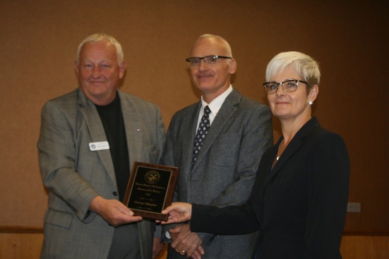 Yorkton Chamber of Commerce president Brent Murdock presents George Gallagher’s lifetime membership to Kelly Gallagher and Shauna Loy, George’s children.