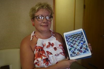 Colleen Koroluk, a leader of the Heart and Home Quilt Club of Kamsack, was recently photographed with a photograph of a quilt that had been made by Lynda Cherwenuk of Kamsack, another member of the club.