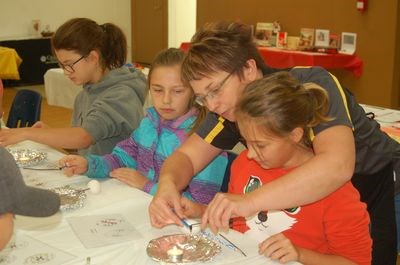 Doreen Bochnuik, left, showed Preeceville School student, Riely Turchinetz a traditional Ukrainian decorated egg.