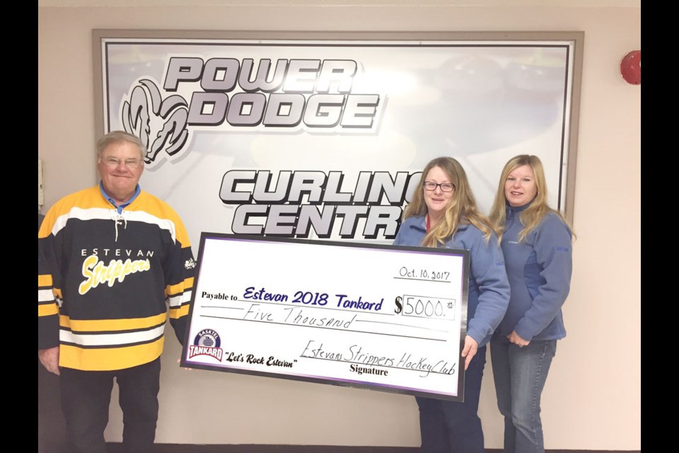 Rick Rohatyn of the Estevan Strippers hockey team gives a $5,000 cheque to Pauline Ziehl Grimsrud, sponsorship committee chair, and Helen Fornwald, Tankard committee co-chair.