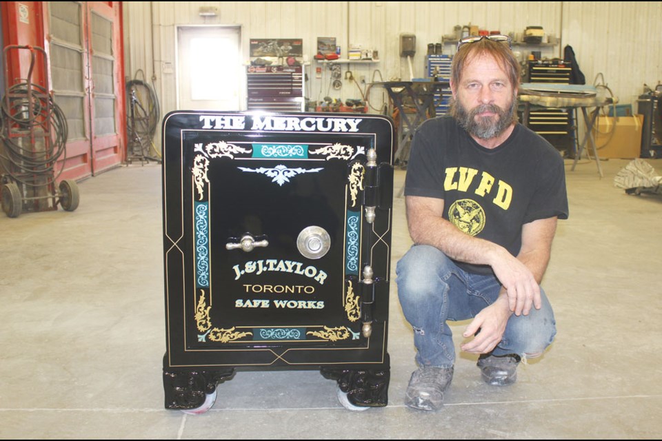 Yancey Hagel stands next to the safe that he has restored. At one time, the safe belonged to the Estevan Mercury.