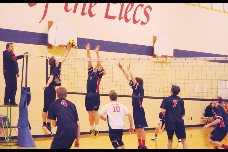 Kayden Ludwig of the ECS Elecs senior boys volleyball team looks to block the ball Saturday afternoon against the Oxbow Black Knights at the ECS home tournament at their gym.