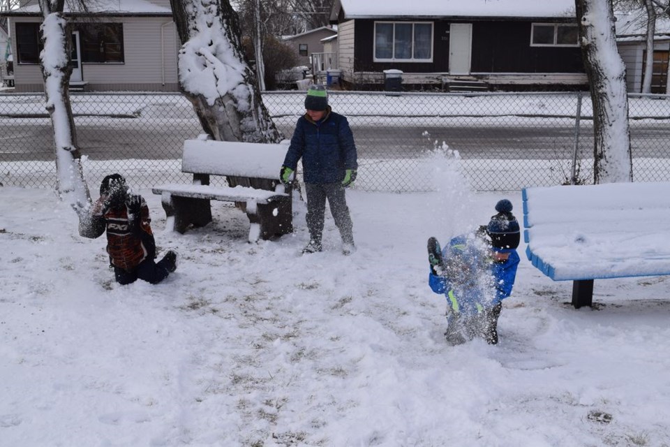 From left, Brayden Fediuk, Chase Curtis and Owen Ostafie made the snow fly on October 26 as they enjoyed the first snowfall of the year on the Canora Junior Elementary School playground.