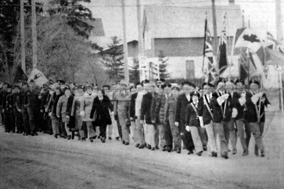 A fresh south wind played on the Canadian flag near the cenotaph at Memorial Park last Friday as veterans paraded post at eyes right.The parade, originally formed up on Main Street near 103rd Avenue, proceeded first to Civic Auditorium where the annual Remembrance Day service was held. Following the service, a party of veterans moved to the cenotaph, the wreaths laid at the Indoor service in preparation for the march past. Accompanying the veterans in the parade were members of Squadron 624 of the Royal Canadian Air Cadets and members of a number of youth groups. Tisdale Recorder File Photo