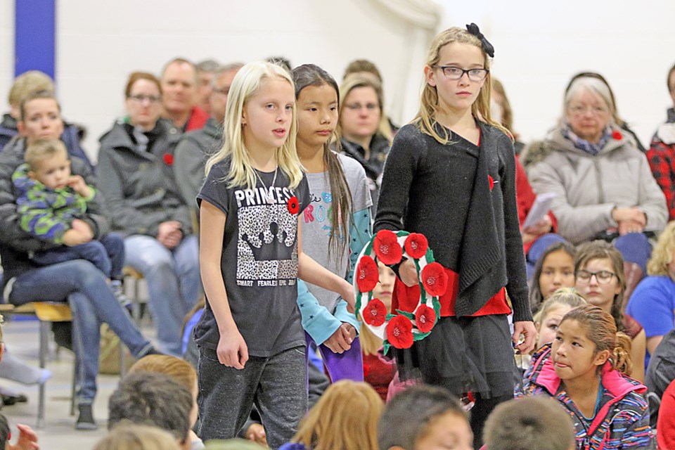 A trio of Nipawin's Wagner Elementary students walk to the front to lay down a wreath during the school’s Remembrance Day ceremony held Nov. 10. Review Photo/Devan C. Tasa