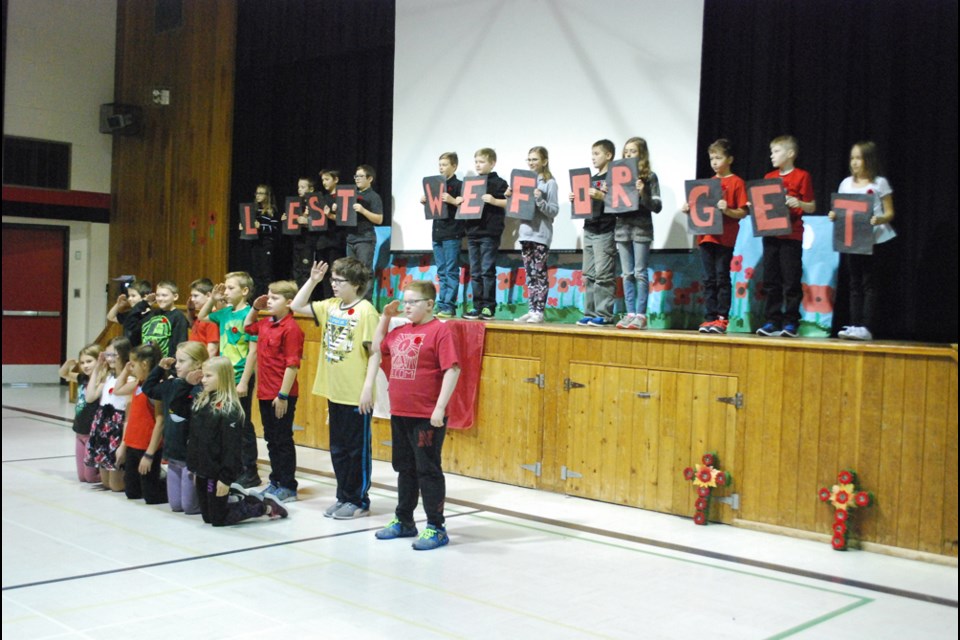 Grade 5 and 6 students perform a dance number to the Trews Highway of Heroes, during the Remembrance Day ceremony at St. Dominic School on Nov. 8. The grade 5 class lead the service. photo by Becky Zimmer