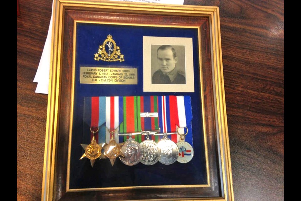 Ed Smith's war medals, including a pin indicating his time spent in the signal corps.