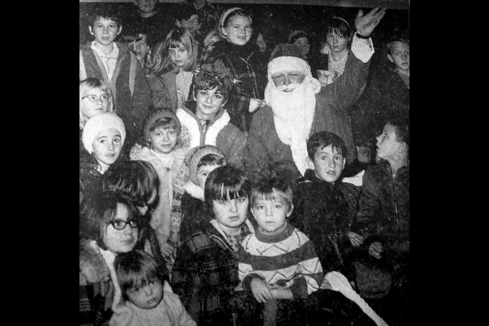Santa Claus and Mary Christmas are surrounded by children during one of the theatre performances at Saturday’s Santa Claus Day in Tisdale. The busy pair attended all three free shows, visited St. Therese Hospital and Sasko Park Lodge. More than 3,600 gifts and prizes were given away to the 1,800 youngsters who attended the shows. Santa and Mary also toured the downtown area by power toboggan, handing out chocolate bars and candy suckers. The day was sponsored by Tisdale businessmen as a treat for the youngsters of the town and district. Tisdale Recorder File Photo