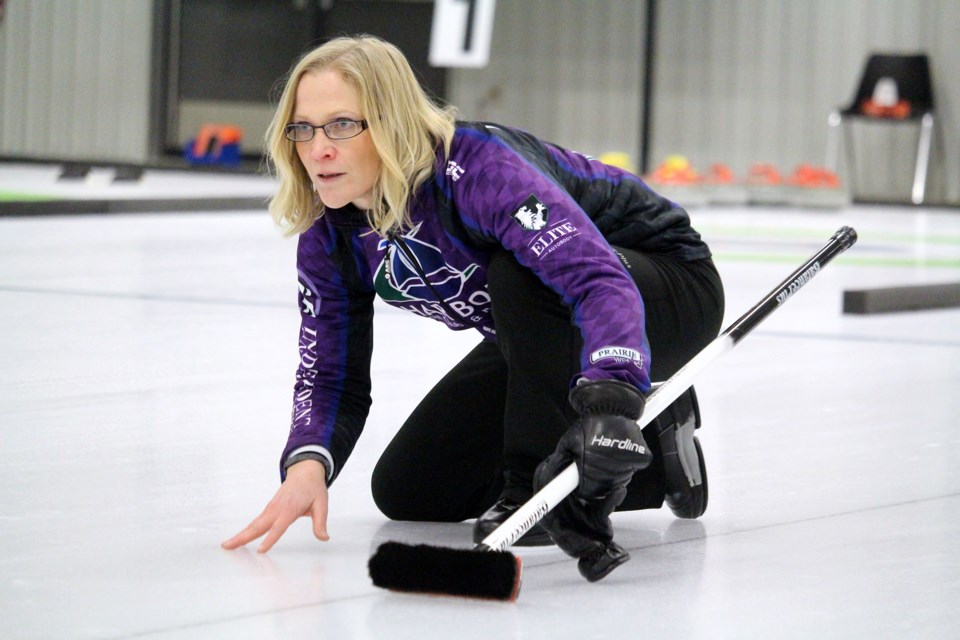 Amber Holland watched her stone head down the ice Saturday at the Twin Rivers Curling Club. Photo by Lucas Punkari