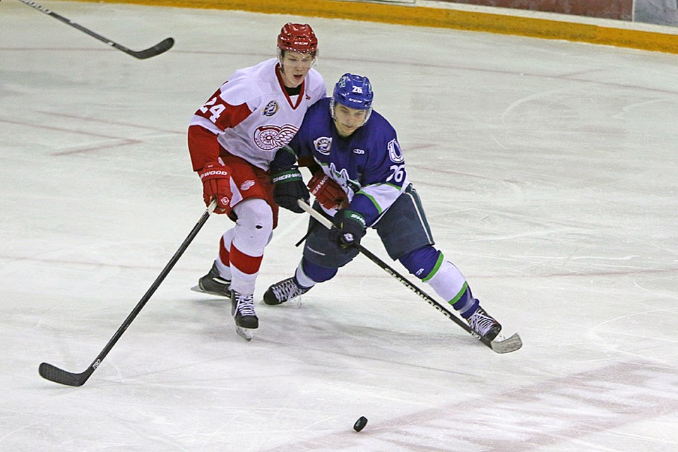 Colin Schmidt of the Mustangs slides towards the puck during the home game against Weyburn Dec. 2. Review Photo/Devan C. Tasa