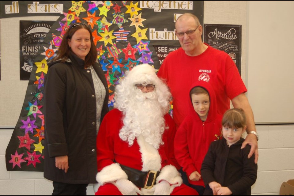 Ron Wagar of Sturgis welcomed special guests from Australia to visit with Santa Claus during the Sturgis Kinsmen Santa day on December 2 at the Sturgis Composite School. Wagar's niece and her children are home for the holidays. With Santa, from left, were: Carla Harris, Ron Wagar and Hayden and Ava Dawes.
