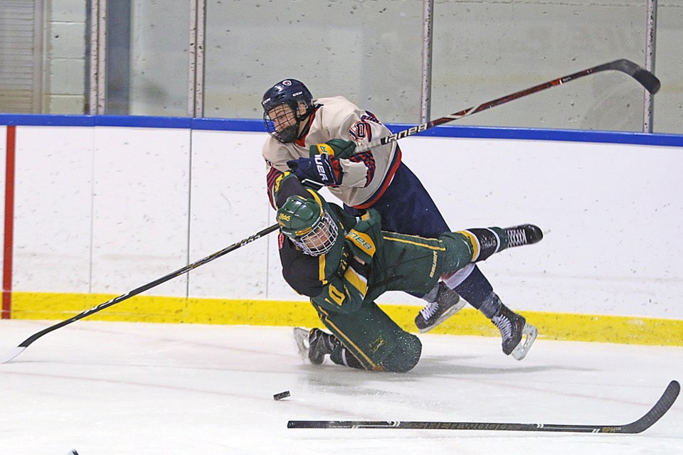 Kalen Ukrainetz of the Trojans runs into a Prince Albert player during the home game Dec. 6. Review Photo/Devan C. Tasa