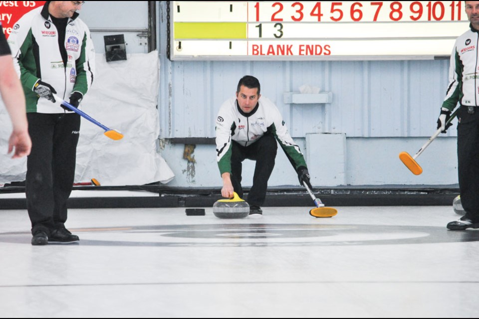 Aryn Schmidt, the second on the Scott Bitz rink from Saskatoon Sutherland, throws a stone.