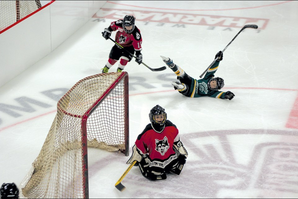 Snow Lake Novice Spartan Brennen Folk-Lapierre celebrates scoring on The Pas Huskies Red during the Mel Pearson Memorial Novice Tournament on Dec. 2. - PHOTO BY ERIC WESTHAVER