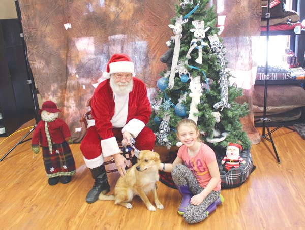 Santa Claus took time out of his busy schedule to stop by Pet Valu in Yorkton on Dec. 9 and take a few holidays photos with owners and their pets such as Maxine Czinkota and her dog Foxer.