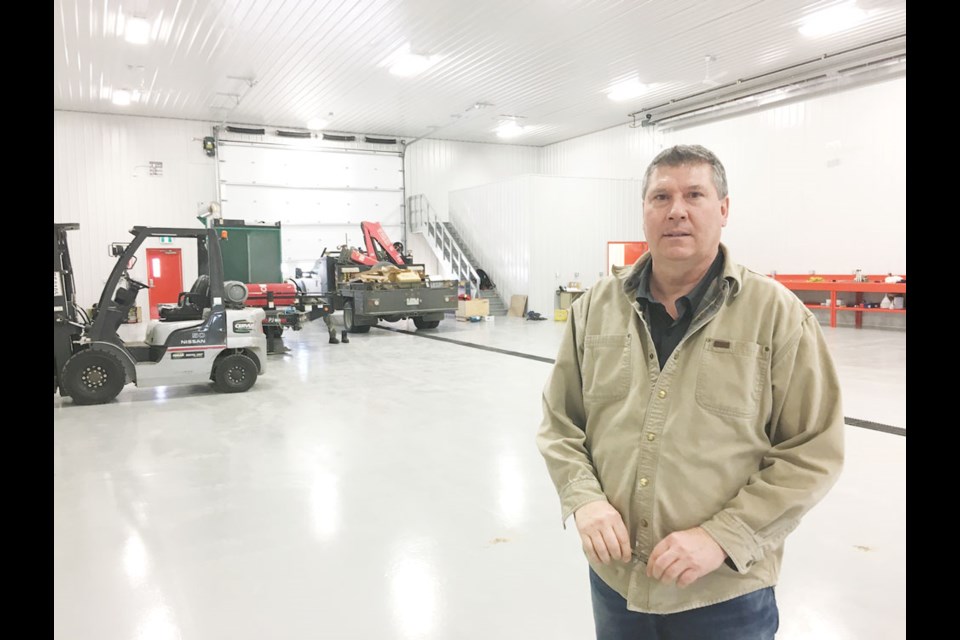 Bob Betts stands in their new shop, whose floors are gleaming. Photo by Brian Zinchuk