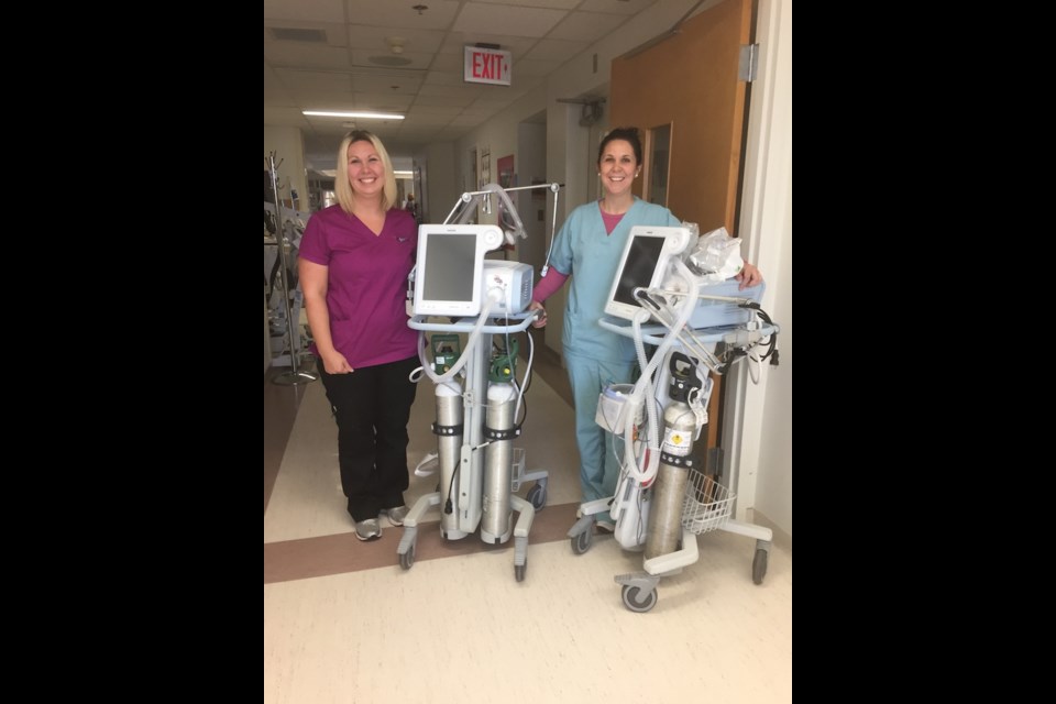 Respiratory therapists Jackelyn Kentel and Julie Stykalo with two ventilators for the Intensive Care Unit.