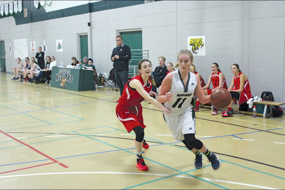 Kodiaks player Taleigh Claveau (right) drives past Hapnot defender Jayde Boyd during the two teams’ semi-final clash at the Kit Classic tournament in Creighton Jan. 13. Hapnot went on to win the game 48-38. - PHOTO BY ERIC WESTHAVER