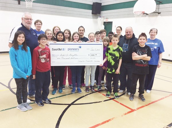 SaskTel Pioneer manager Darrell Leibrecht along with Yorkton SaskTel Pioneer club members Bob Hume, Wendy Hume, and Norene Hume present a cheque for $1,000 to Saltcoats School. This donation from Chapter 59 of the organization will help to support the Grade 5 and 6 Gazette newspaper program and their annual camping trip.