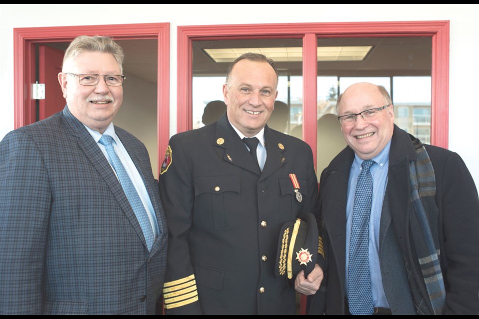 MLA Dan D’Autremont, Weyburn fire chief Simon Almond and MP Robert Kitchen post for a photo at the fire hall grand opening