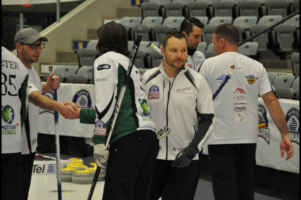 Brent Gedak's team shakes hands with the Scott Bitz team after Saturday's match.