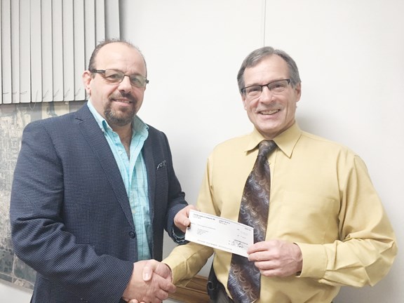 Reeve Randy Trost presented a cheque for $1,500 from the RM of Orkney to Ross Fisher, executive director of the Health Foundation, help purchase the surgical microscope needed for the cataract surgery program.