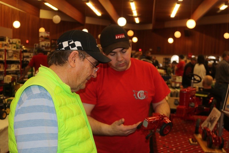Scott Warrington discusses tractors with a passerby at the Yorkton Farm Toy Show on Saturday.
