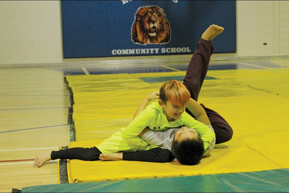 Judo students Dane Collard and Roderick Caribou practice holds during a Jan. 29 class at Ruth Betts Community School. - PHOTO BY ERIC WESTHAVER